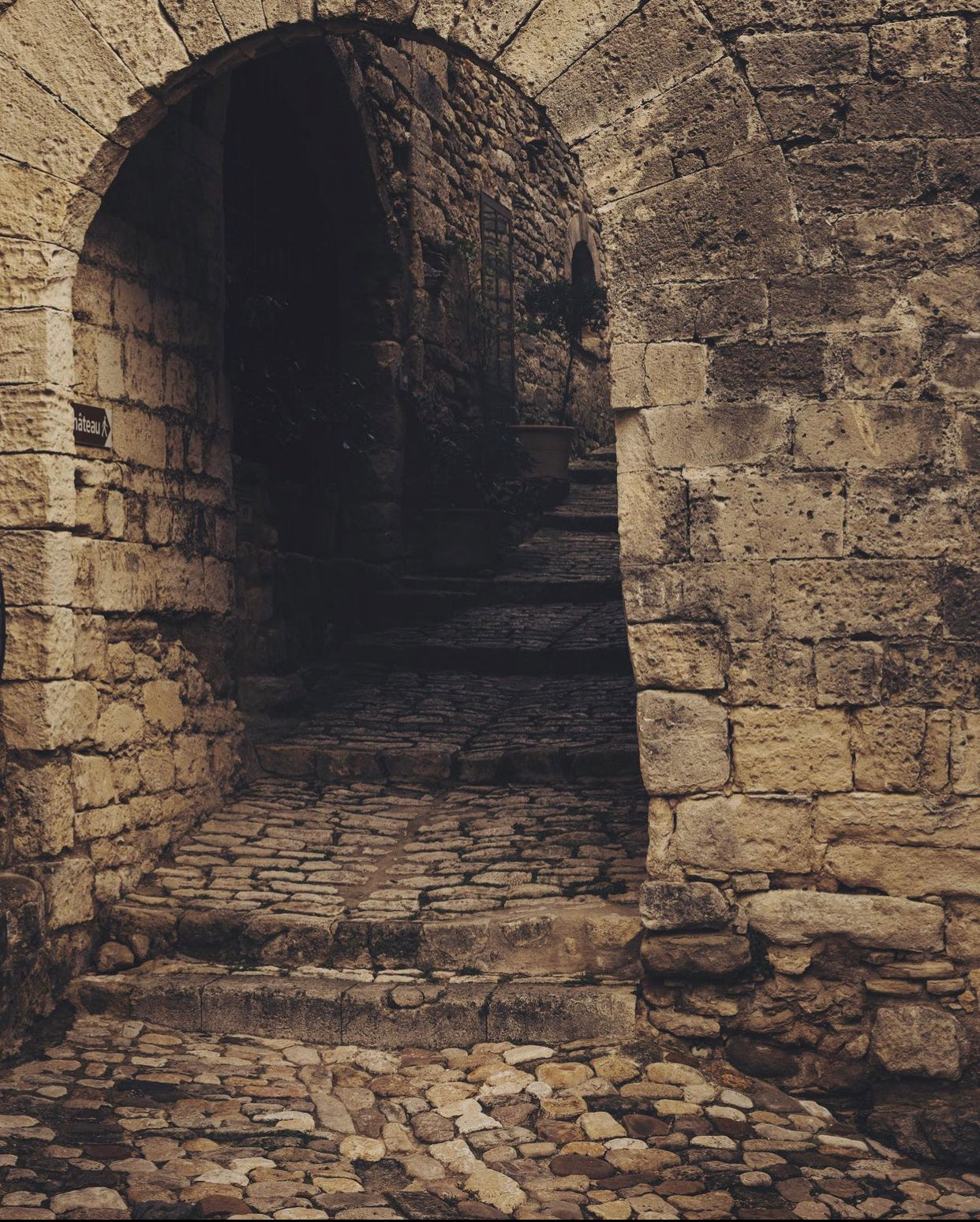 photo of cobblestone archway in French country village